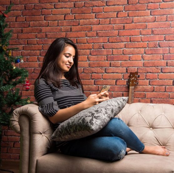 woman texting on a couch